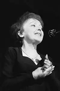 Photo of Édith Piaf at the microphone.