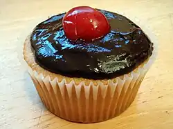 Cupcake topped with a maraschino cherry