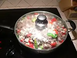 Adding onions and peppers
