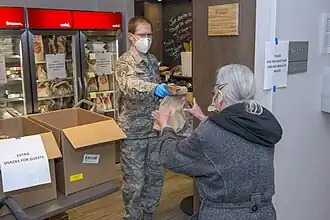 A Colorado National Guardsman offering food aid in Denver.