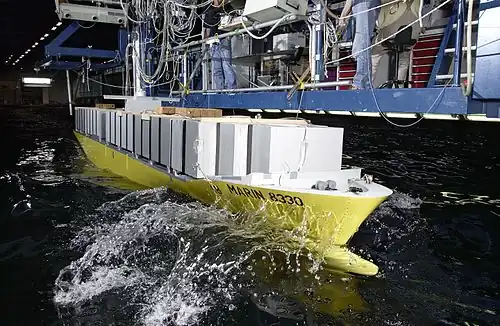 Container ship model undergoing testing.