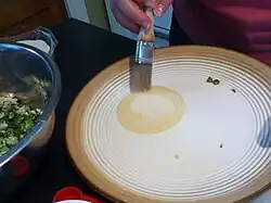 Step 2: Brush a gyoza wrapper with a little water around the edges.