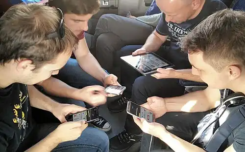 People playing a multiplayer game on their smartphones.