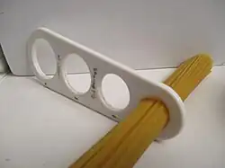Utensil used to measure volumes of dried spaghetti