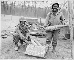 One holds an artillery round with "Happy Easter Adolf" written on it