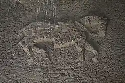 Large low-relief depiction on the interior side of the stone lintel above the entry.