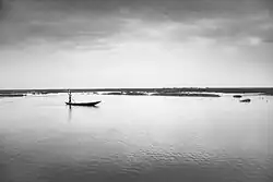 A Marsh Arab poles a mashoof in Al-Chibayish District