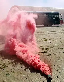Smoke billowing from a red M18.