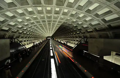 A train departs from McPherson Square (opened 1977), which has an original ceiling vault design.