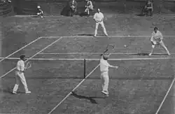 1912 International Lawn Tennis Challenge (Davis Cup) finals match between Australasia and the British Isles played at the Albert Ground in Melbourne, Australia on 28–30 November. Players shown on the near side are Alfred Dunlop (left) and Norman Brookes (right) for Australasia and on the far side James Cecil Parke (left) and Alfred Beamish (right) for the British Isles.