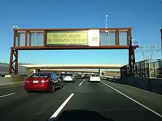A Daktronics rear access color LED sign on the New Jersey Turnpike, USA, displaying a warning about congestion ahead.