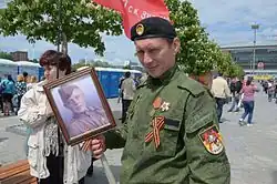 Sparta Battalion soldier wears an EMR uniform and a Ribbon of Saint George during the 2016 Victory Day parade in Donetsk.