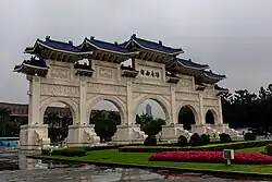 White gate with blue roof and five arches