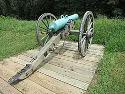 Photo show carriage-mounted gun with bronze patina.