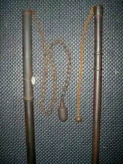 Two Japanese chigiriki, chain and weight weapons, one with a hollow iron staff and one with a hollow wood and iron staff