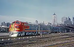 Red and silver locomotives with skyline behind
