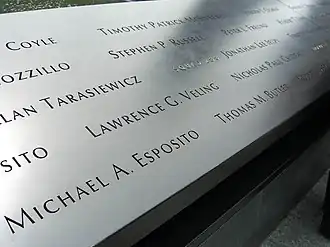At the South Pool of the National September 11 Memorial, Panel S-7 is one of the three on which names of Squad Company 1 members can be seen. Visible in the photo are those of Michael A. Esposito and Thomas M. Butler along the bottom of the panel