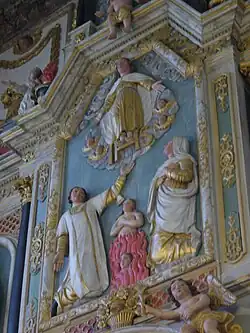 In the tableau in the centre of the altarpiece's upper section, Christ, surrounded by angels, receives the souls which Saint Dominic and Catherine of Sienna have rescued from the flames of purgatory