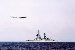 A Tu-95 Bear overflies a Sverdlov-class cruiser 1975