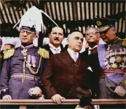 Color photo of Vargas in civilian dress surrounded by four other men, two in uniform