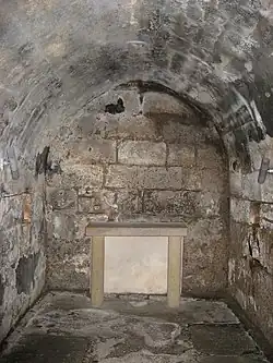 An underground stone lined crypt.