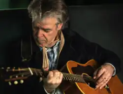 Dutch singer-songwriter Ad Vanderveen playing guitar