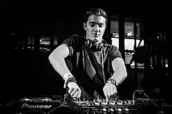 Black and white photo of Alesso as a DJ.