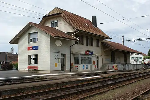 Two-story building with gabled roof and single-story wings