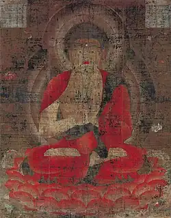 Frontal view of a cross-legged deity.