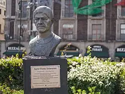 Bronze bust of a man with indigenous features in his 30s.