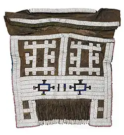 A beaded apron or meputo; late 19th-early 20th century; hide, glass beads, metal beads, straw; 46.9 cm × 50.8 cm (18.5 in × 20.0 in); Birmingham Museum of Art (Alabama, USA)