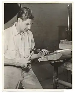 José Ruiz de Rivera carving wood with hammer and chisel