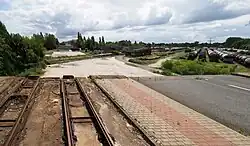 Road and two tram tracks cut off at the end of a demolished bridge
