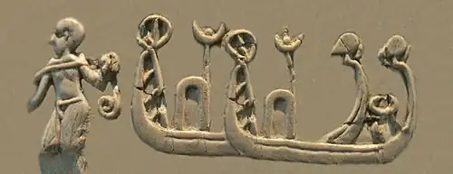 Shaven-headed man towing high-prowed boats, of a type seen on Sumerian Uruk period seals and artworks.[40] Possibly part of the depiction of a naval battle.[41][34][42] (Front, 3rd register)