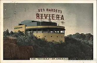 Picture postcard showing the Riviera atop a cliff. The front of the building is semicircular with a row of windows across the top. Above the building is a large sign with individual letters: the top row says "BEN MARDEN'S" and below that in much larger letters, "RIVIERA".