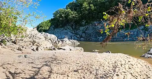 The Purplehorse "Beach". No swimming here: river is dangerous and people drown.