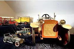 Assorted toy cars and pedal car