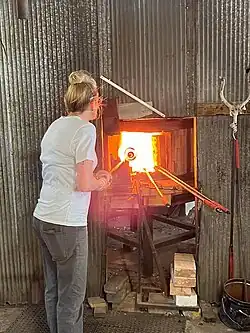 glassware held in firey oven by pipe