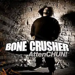 The cover features Bone Crusher decked in all black clothing, standing in front of a crumbling rock wall, with various skeleton bones beneath him. Both the artist's name and album title appear in front of him, colored in white and grey respectively.