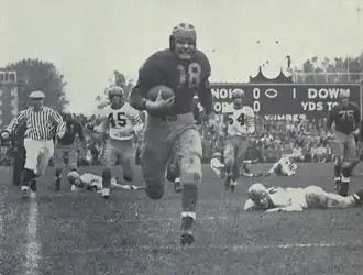 Photograph of Bump Elliott on a 74 yard touchdown run for Michigan's first touchdown against Illinois in 1947