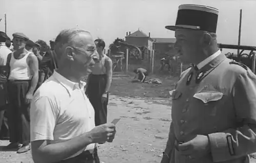 A prisoner in conversation with a French gendarme.[note 1]