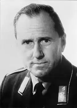 A black and white photograph, from the chest up, of an old man wearing a uniform