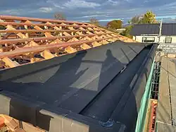 Photo of a small Butynol roof installation showing the seamless and smooth synthetic rubber membrane applied to a flat roof on a residential building in New Zealand
