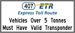 "Vehicles Over 5 Tonnes Must Have Valid Transponder" sign, located before entrance ramps to hwy. 407, also known as the ETR.