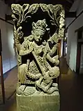 Carving of deity on wooden pillar