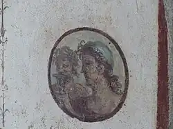Roundel with heads of satyrs in room f