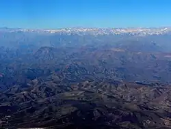 Wide view observatories from the air, including Cerro Pachón. In the distance are the Andes
