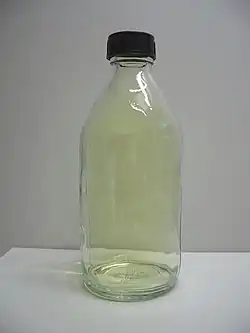 A glass container filled with yellow chlorine gas