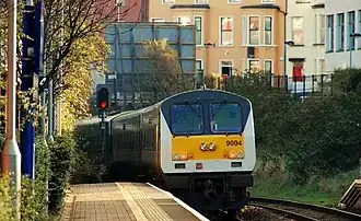 The Enterprise train passing through the station in 2009 on route to Belfast Central; now Lanyon Place