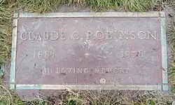 Flat bronze plaque including him name, with birth and death years